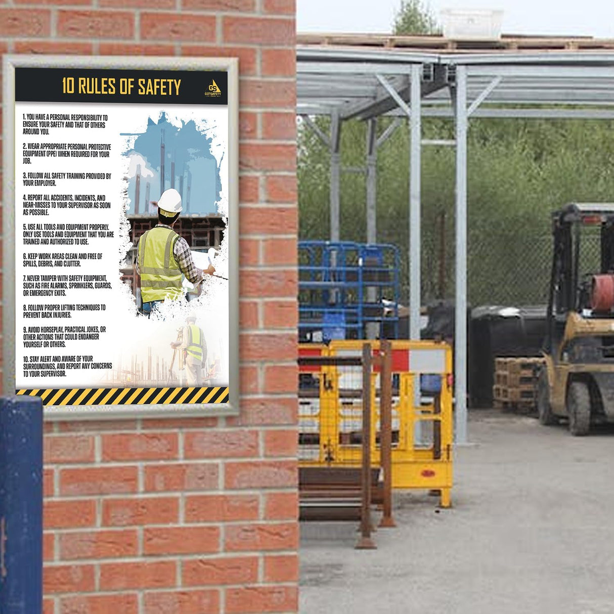 GotSafety 10 Rules of Safety poster mounted on a brick wall at an outdoor construction site with a forklift in the background — laminated 24x32 workplace safety poster